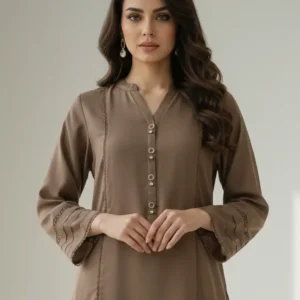 A full-length studio shot of a model wearing the Sairi Wardrobe Mocha 2-piece Ready To Wear linen set. The outfit features a long, straight-cut mocha brown kurta with vertical lace detailing, pleated sleeve cuffs, and matching tailored trousers. The model is posed in a minimalist white room with soft window light, wearing nude pointed-toe heels.
